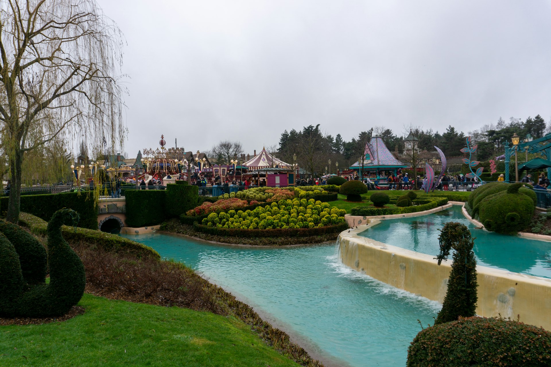 a water park with a small pond surrounded by trees